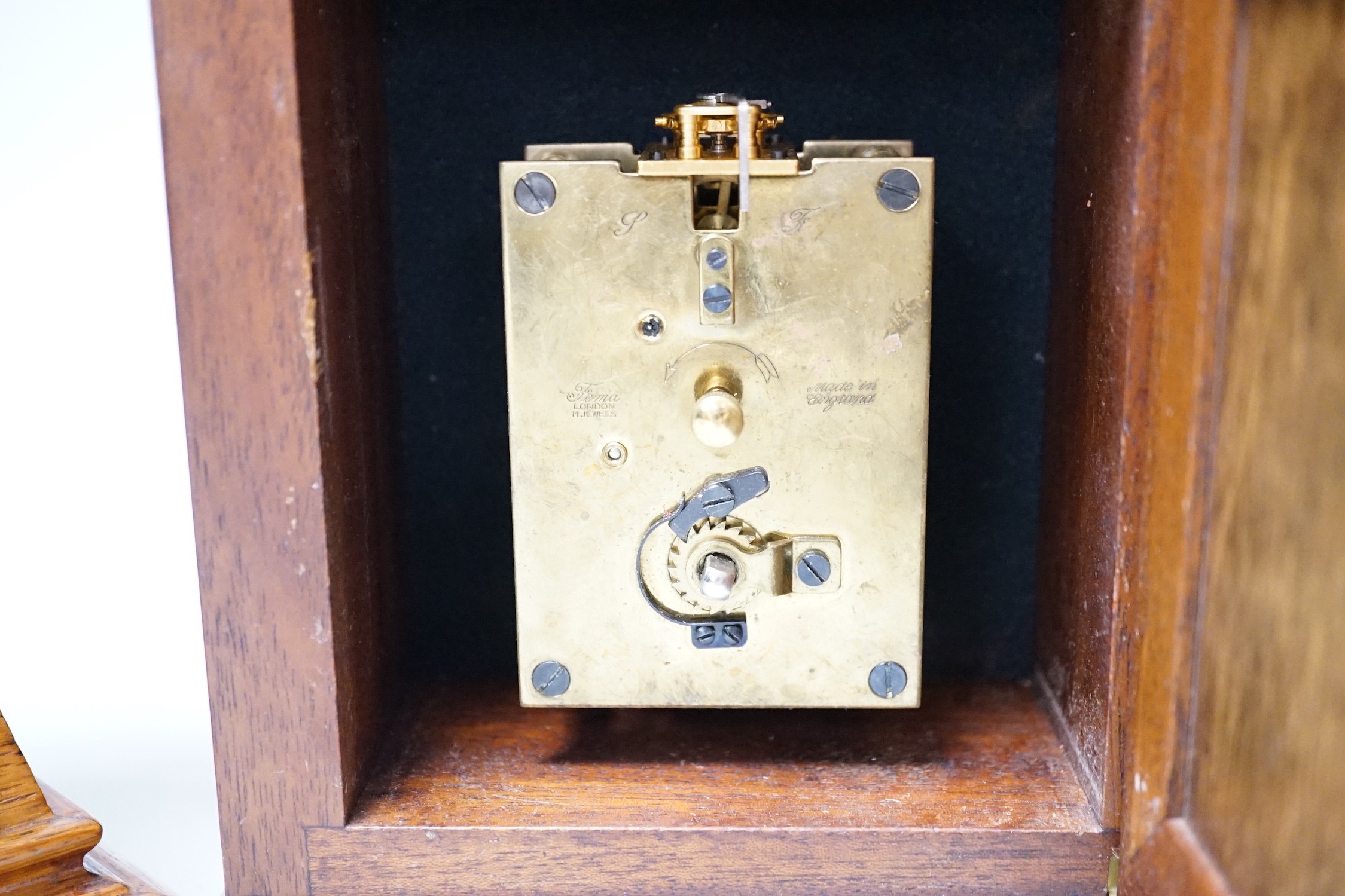 A Garrard clock and an oak brass mounted clock 29cms high